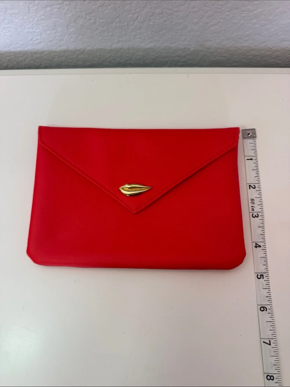This is a red Ipsy Sealed with a Kiss makeup bag NWOT